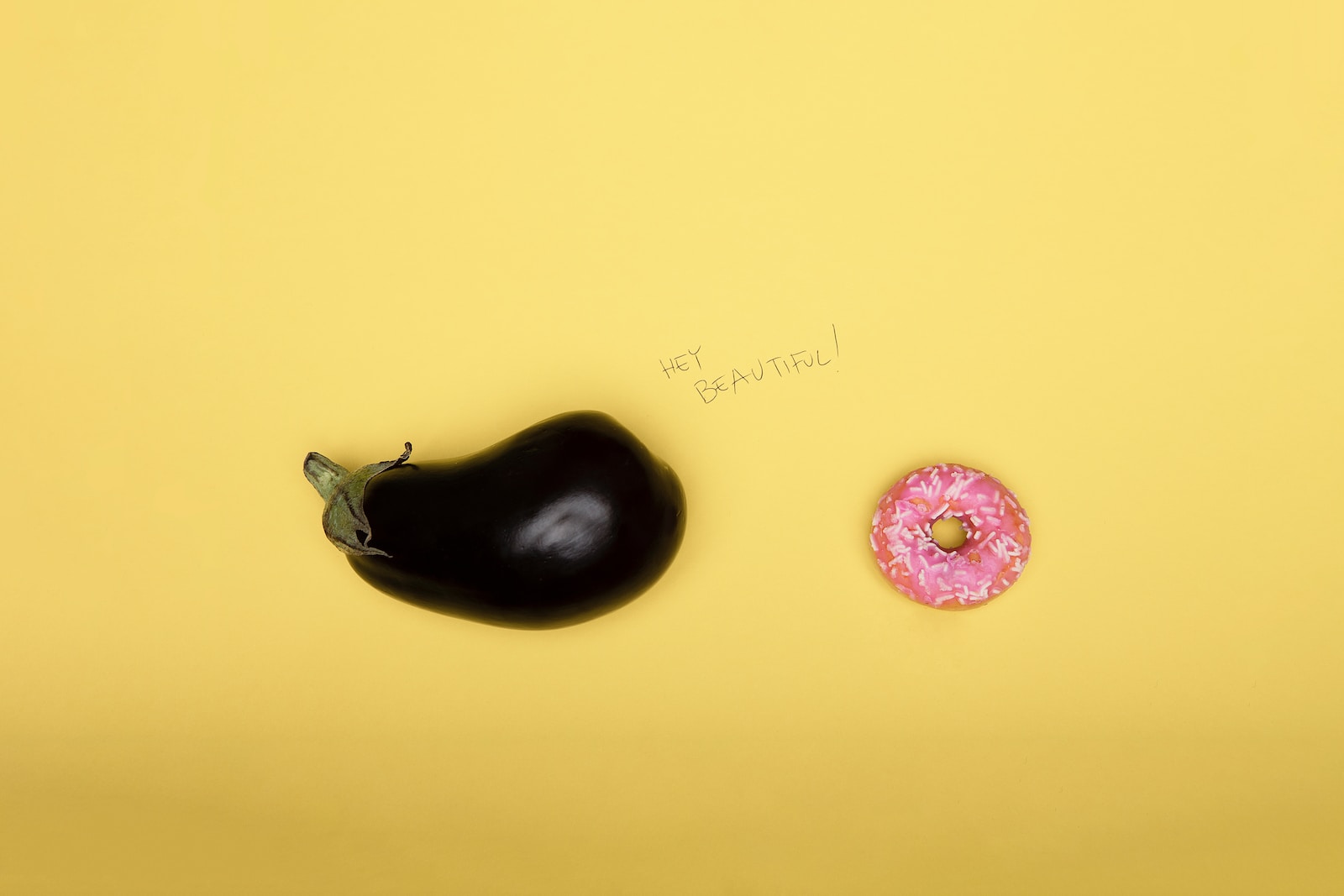 pink doughnut on yellow surface